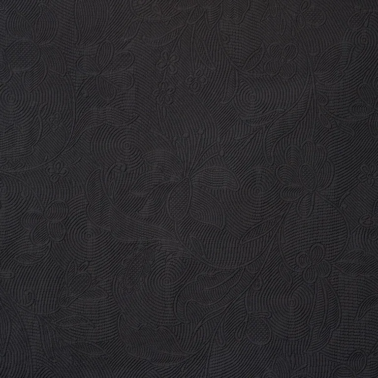 Schumacher 81591 Quilted Scroll Matelassé Pitch Black fabric swatch