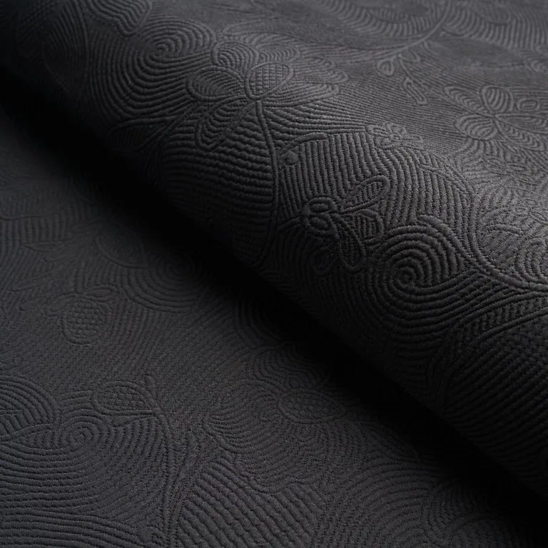 Schumacher 81591 Quilted Scroll Matelassé Pitch Black fabric swatch
