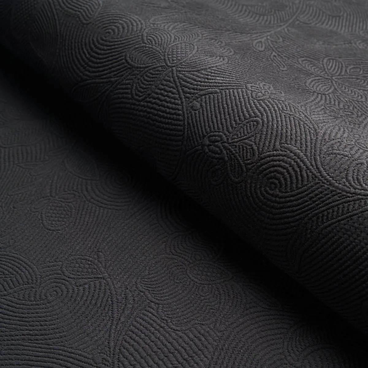 Schumacher 81591 Quilted Scroll Matelassé Pitch Black fabric swatch