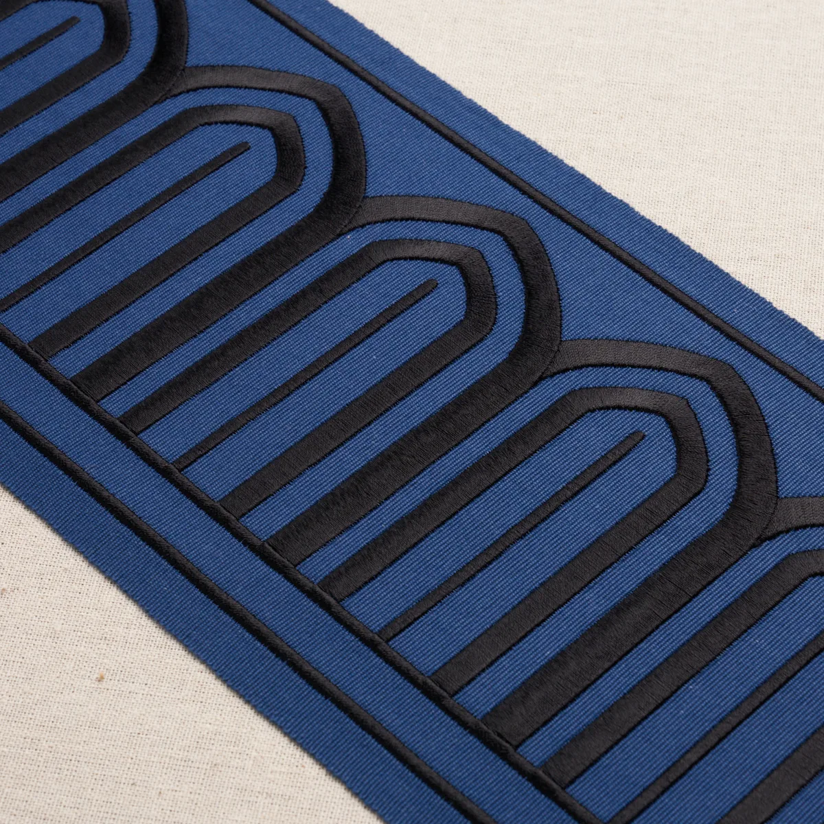 81160 | Arches Embroidered Tape Wide - Black on Navy Schumacher Arches Embroidered Tape Wide trim in Black on Navy (81160)