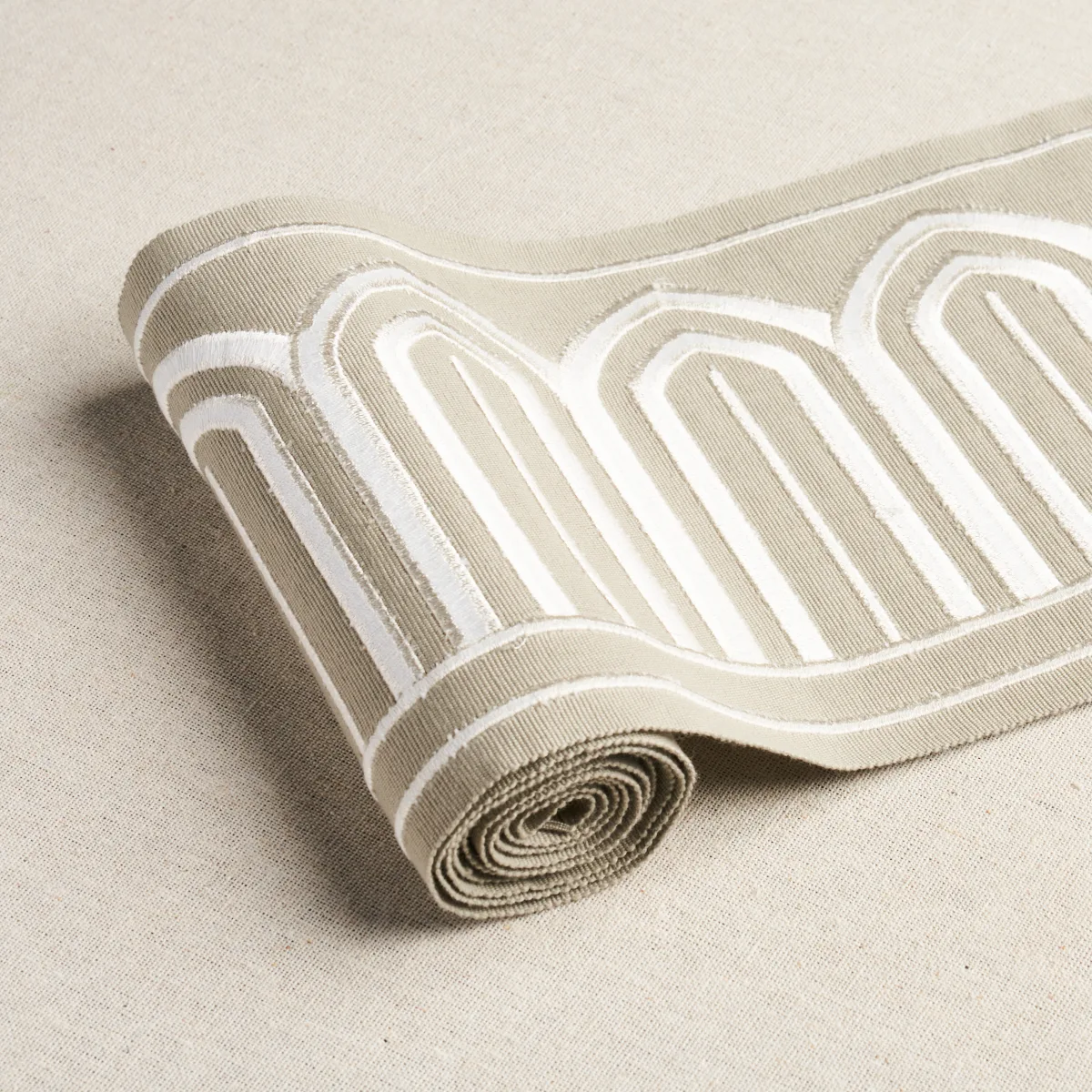 70776 | Arches Embroidered Tape Wide - Taupe Schumacher Arches Embroidered Tape Wide trim in Taupe (70776)