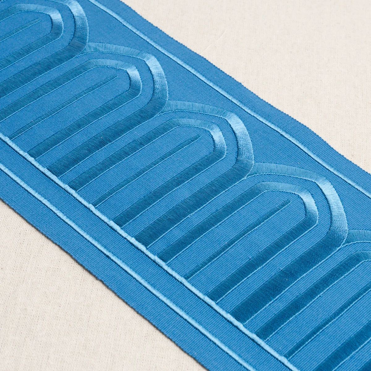 81161 | Arches Embroidered Tape Wide - Teal Schumacher Arches Embroidered Tape Wide trim in Teal (81161)