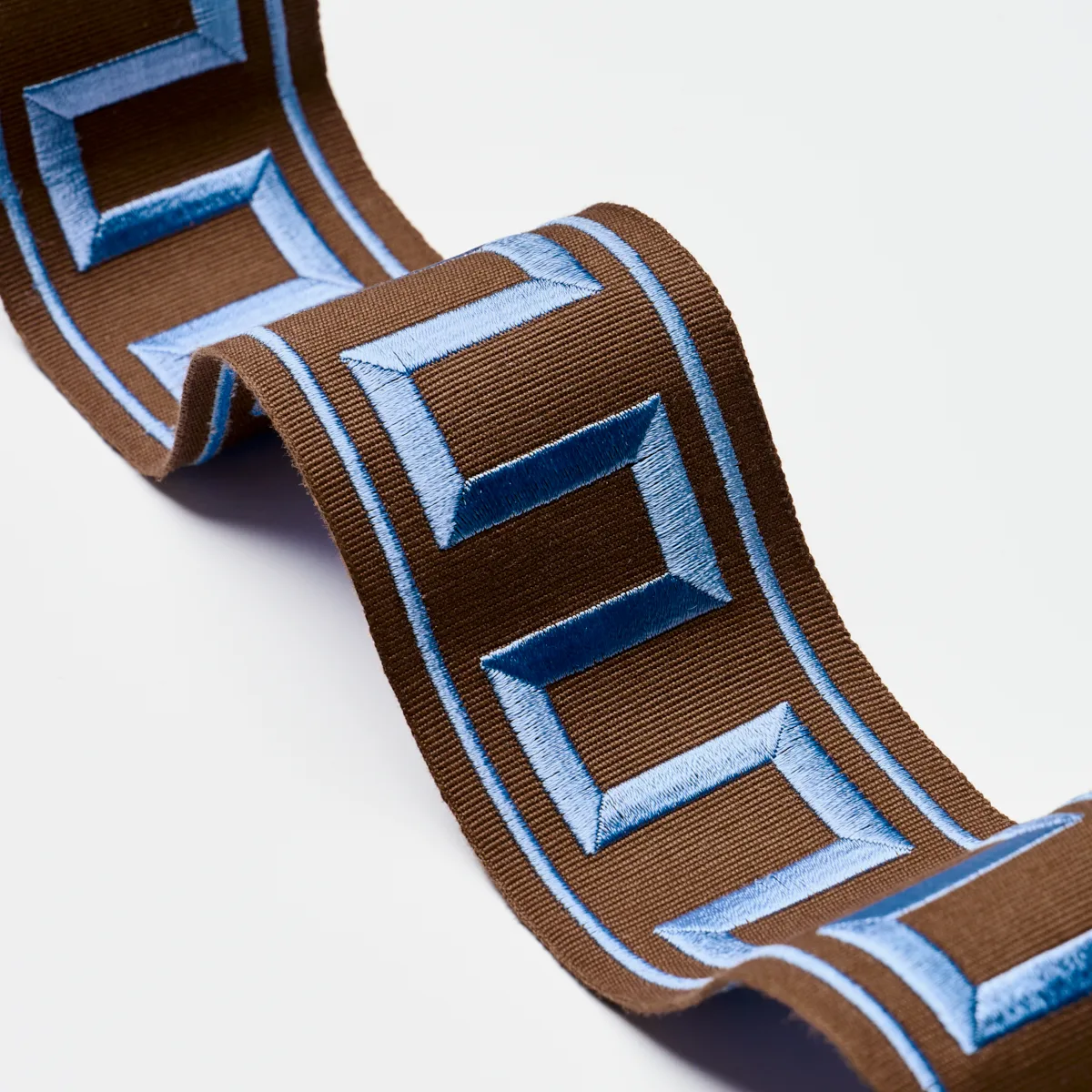 70807 | Greek Key Embroidered Tape - Blue on Brown Schumacher Greek Key Embroidered Tape trim in Blue on Brown (70807)