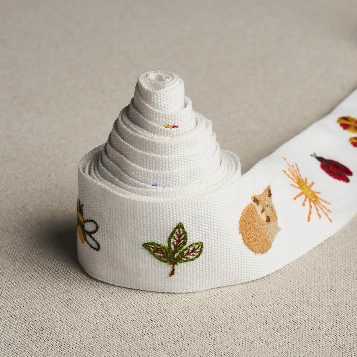 81680 | Tiny Things Embroidered Tape - Multi on Ivory Schumacher Tiny Things Embroidered Tape trim in Multi on Ivory (81680)