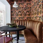 House of Hackney Phantasia wallpaper in Selenite Orange, blooms and animal markings in selenite orange
